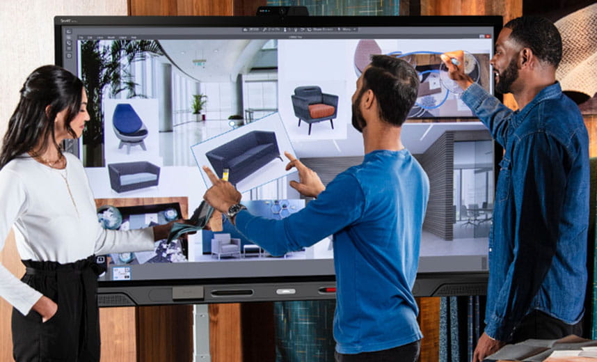 Three professionals collaborating on a SMART Board, designing an interior space with interactive tools.