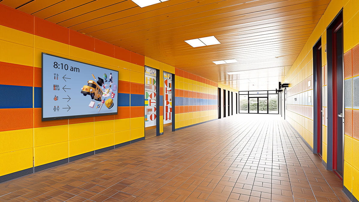 School hallway featuring a SMART Board NX series non-interactive display with wayfinding icons and school bus graphic.