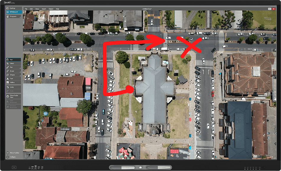 Interactive display showing a detailed satellite image of city streets and buildings, highlighted with annotations for route planning.